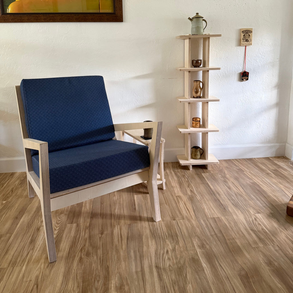 Modern interior design with a chair, wall art, and decorative elements.